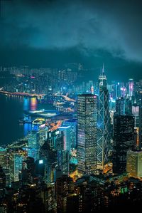 Illuminated buildings in city against sky at night