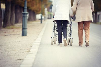 Low section of people walking on road