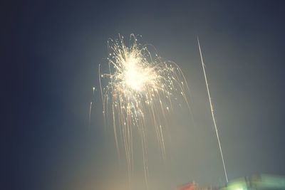 Low angle view of firework display at night