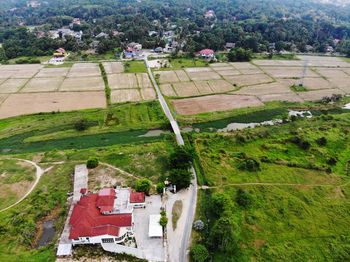 High angle view of agricultural field by buildings