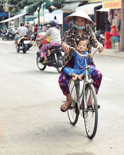 People riding bicycle on street