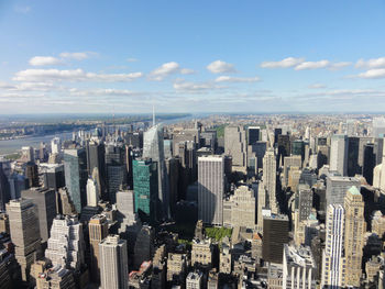 Aerial view of modern buildings in city against sky