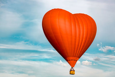 Low angle view of hot air balloon flying against sky