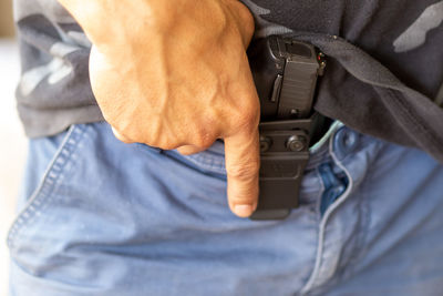 Midsection of man holding hands