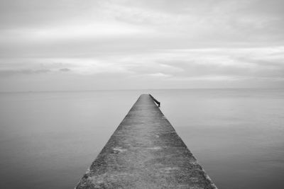 Groyne amidst sea against sky