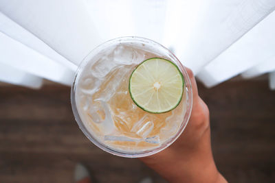 Close-up of hand holding glass of juice