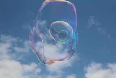 Low angle view of bubbles against sky