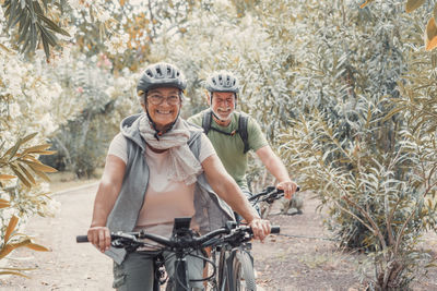 Portrait of man riding bicycle on field