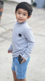 Portrait of cute boy standing outdoors