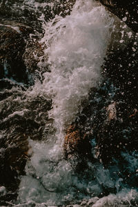 High angle view of water splashing on rocks