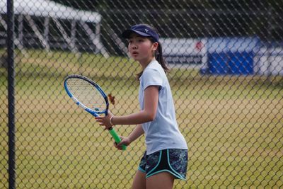 Midsection of woman playing tennis