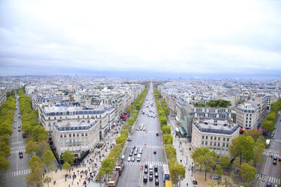 High angle view of paris city street against cloudy sky