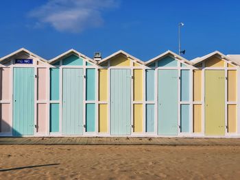 Beach huts against blue sky