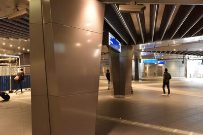 Man walking on illuminated railroad station at night