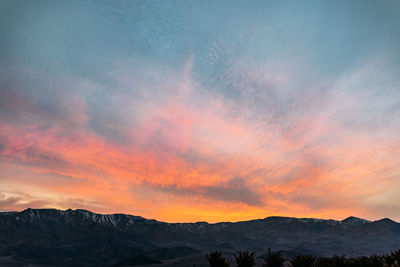 Scenic view of silhouette mountains against sky during sunset