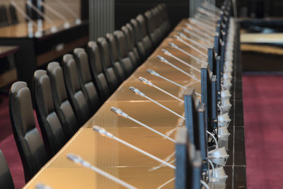 High angle view of empty seats and microphones in room