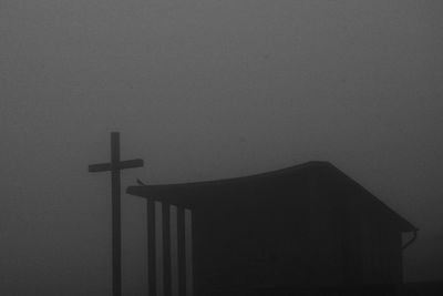 Low angle view of cross against sky