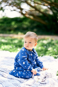 Cute boy sitting outdoors