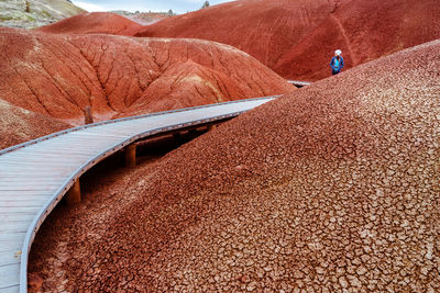 Young woman walking on boardwalk at painted hills