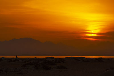 Scenic view of sea against romantic sky at sunset