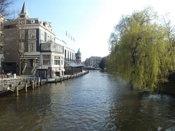 River amidst buildings against clear sky