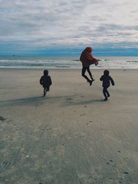 People on beach against sky