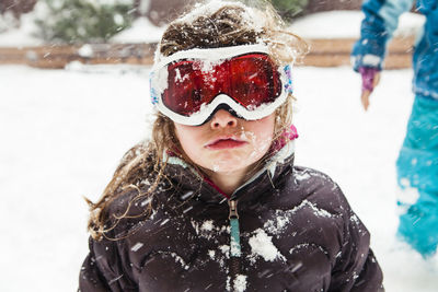 Girl wearing ski goggles during winter