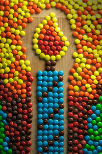 Full frame shot of candle made from colorful candies on table