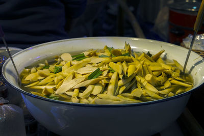 Close-up of yellow flowers in bowl on table