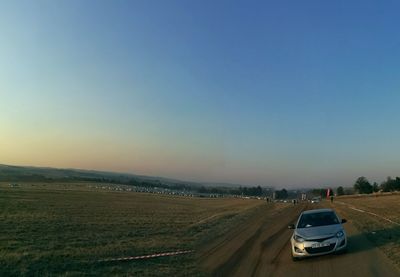 Cars on road against blue sky