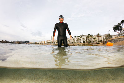 Full length of man standing in sea