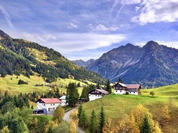 Scenic view of houses and mountains against sky