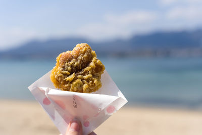 Close-up of hand holding ice cream