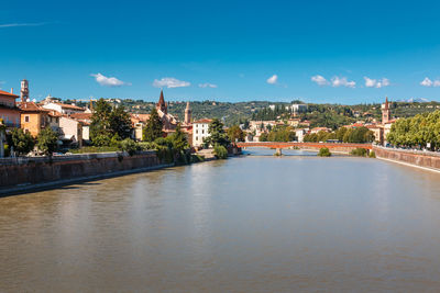 River amidst buildings in city against sky