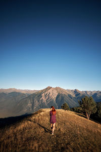 Rear view of woman walking on mountain 