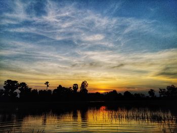 Scenic view of lake against sky during sunset