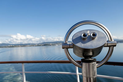 Close-up of binoculars against sky