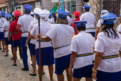 Women dressed as sailors are seen parading through the streets of the city of saubara, in bahia.