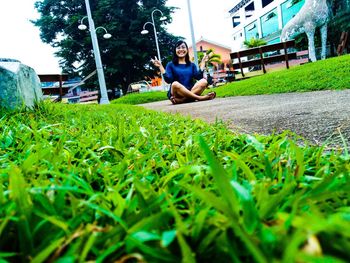 Full length of boy sitting on grass