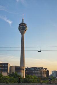 View of rhine tower which cross rhine river during sunset time in düsseldorf, germany