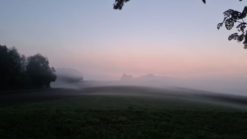 Scenic view of field against sky during sunset