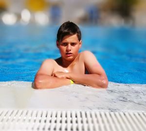 Portrait of young woman relaxing in swimming pool