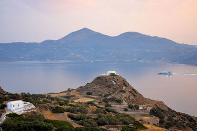 Scenic view of sea and mountains against sky