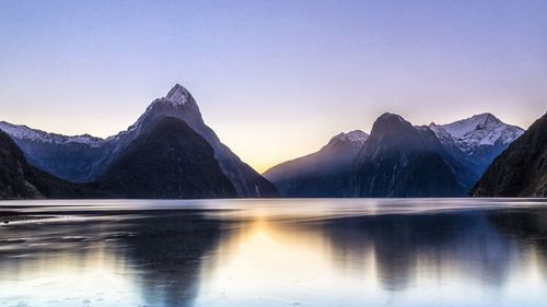 Scenic view of lake and mountains against clear sky