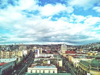 Cityscape against cloudy sky