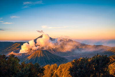 Smoke emitting from volcanic mountain against sky