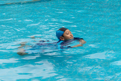 High angle view of boy swimming in pool