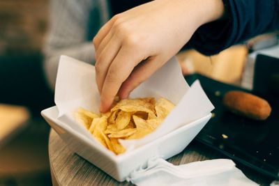 Close-up of person holding food on table