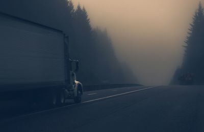 Truck on road during foggy weather