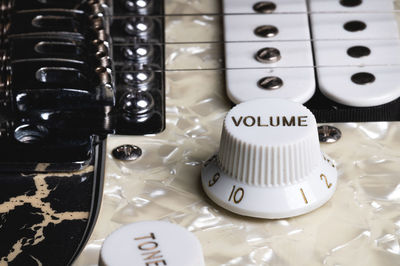 Close-up of electric guitar pickups and volume knob